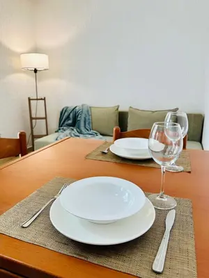 a table with two plates and a glass of wine at SweetHome in Sutomore
