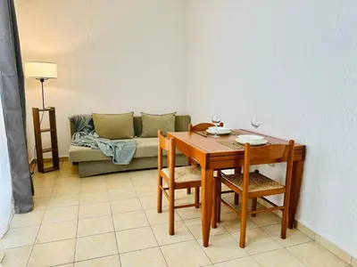 a living room with a table and a couch at SweetHome in Sutomore