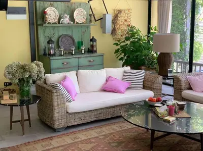 a living room with a white couch and pink pillows at Andrej home in Golubovci