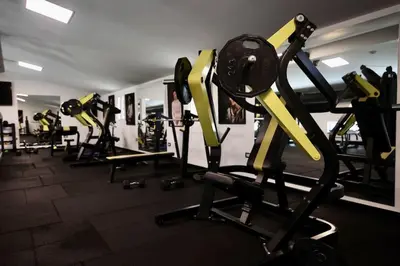 a gym with several rows of treadmills and machines at Andrej home in Golubovci