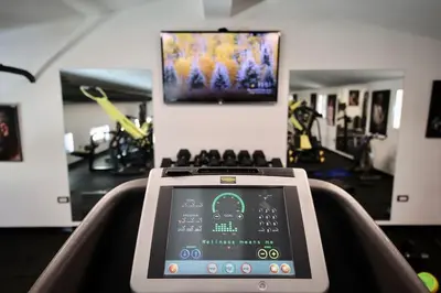 a gym with a tablet sitting on a treadmill at Andrej home in Golubovci