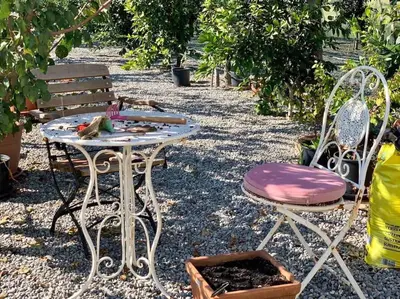 a table and two chairs and a bench in a garden at Andrej home in Golubovci