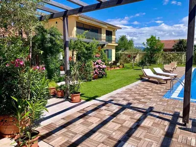 a patio with chairs and plants in a yard at Andrej home in Golubovci