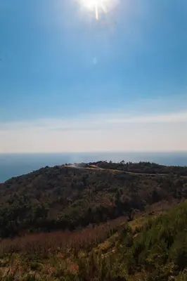 a view of a hill with the ocean in the background at Tophill Altezza 9 best view and pool in Budva
