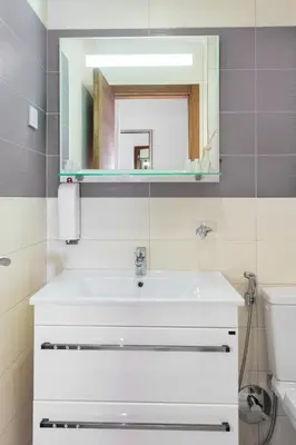 a bathroom with a white sink and a mirror at Tophill Altezza 9 best view and pool in Budva