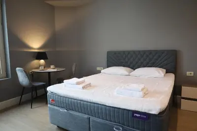 a bedroom with a large bed with towels on it at Status-M Apartments Franca sea view in Budva