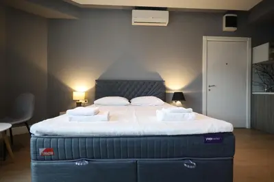 a bedroom with a large bed with white sheets and pillows at Status-M Apartments Franca sea view in Budva
