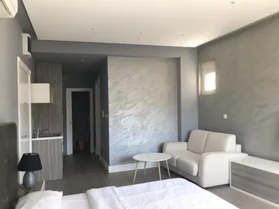 a living room with a white couch and a table at Status-M Apartments Franca sea view in Budva
