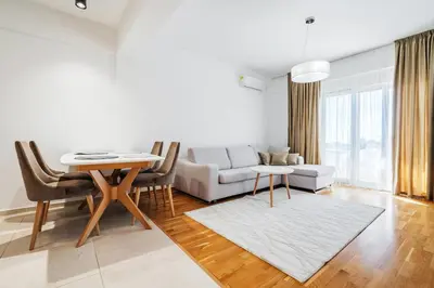 a living room with a couch and a table at Status-M Apartments 153 in Becici