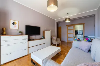 a living room with a couch and a tv at Lovely Studio with Panoramic City View in Budva