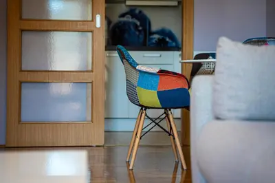 a colorful chair sitting in front of a door at Lovely Studio with Panoramic City View in Budva