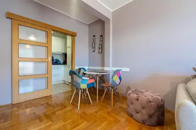 a living room with a table and chairs at Lovely Studio with Panoramic City View in Budva