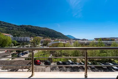a view of a city from a balcony at Lovely Studio with Panoramic City View in Budva