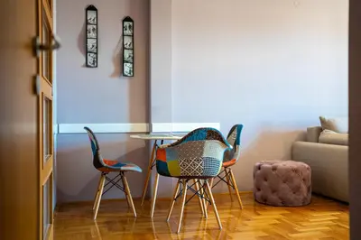two chairs and a table in a living room at Lovely Studio with Panoramic City View in Budva
