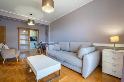 a living room with a couch and a table at Lovely Studio with Panoramic City View in Budva