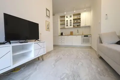 a living room with a flat screen tv and a couch at Status-M Apartments Aura in Becici