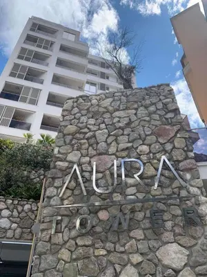 a sign on a stone wall in front of a building at Status-M Apartments Aura in Becici
