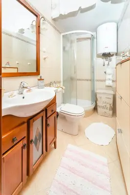 a bathroom with a sink and a shower and a toilet at Harmony Budva Apartment in Budva