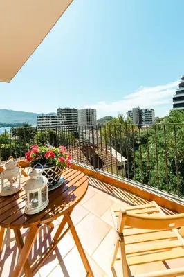 a balcony with a table and chairs and a view at Harmony Budva Apartment in Budva