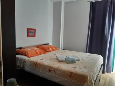 a bed with two towels on it in a bedroom at Apartmani Jaz 24 in Budva
