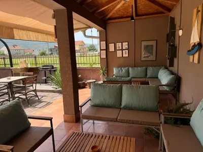 a patio with couches and a table and chairs at Apartmani Jaz 24 in Budva