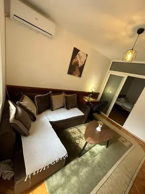 a living room with a couch and a table at Budva App4 in Budva