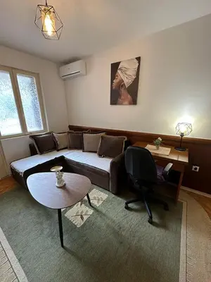 a living room with a couch and a table at Budva App4 in Budva