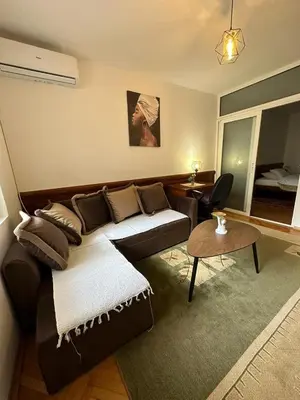 a living room with a couch and a table at Budva App4 in Budva