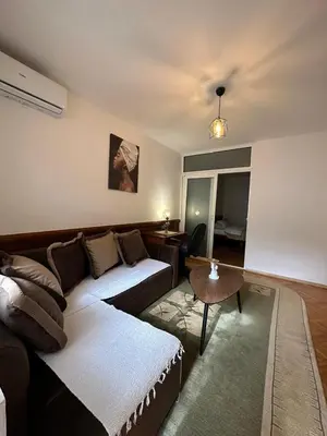 a living room with a couch and a table at Budva App4 in Budva