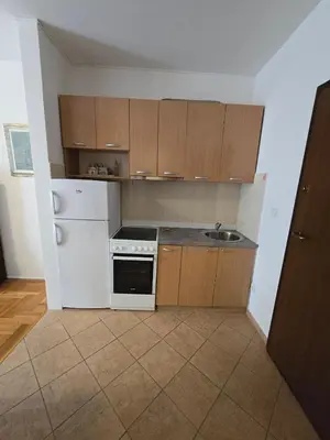 a kitchen with a white refrigerator and a sink at Laki Apartment in Podgorica