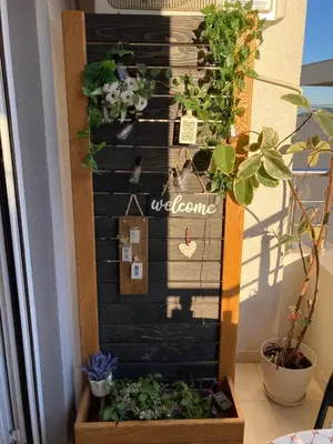 a welcome sign on a wall with plants at Budva City De Lux in Budva