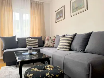 a living room with a couch and a table at Budva City De Lux in Budva