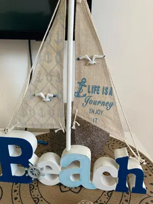 a toy sail boat with a life is a journey sign at Budva City De Lux in Budva