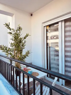 a balcony with a table and a plant at Queen of the Beach in Bar