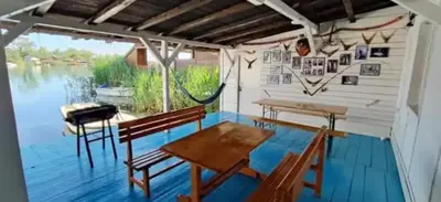 a room with a table and chairs on a deck at Kucica Truma in Ulcinj