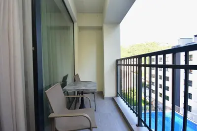 a balcony with a table and chairs on a balcony at Brand New ! Seaside Apt with Poolview & Parking in Budva