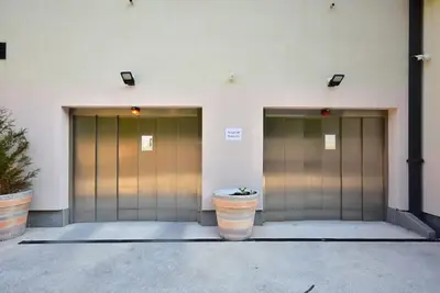 a group of four metal doors in a building at Brand New ! Seaside Apt with Poolview & Parking in Budva