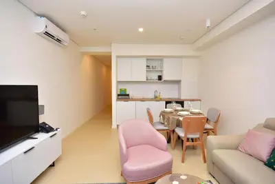 a living room with a table and a dining room at Brand New ! Seaside Apt with Poolview & Parking in Budva
