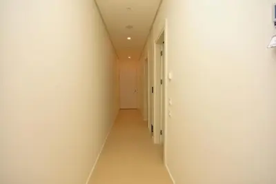 an empty hallway with white walls and a white ceiling at Brand New ! Seaside Apt with Poolview & Parking in Budva