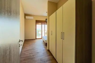 a hallway with a room with a bed and a door at PETROVIĆ in Bar