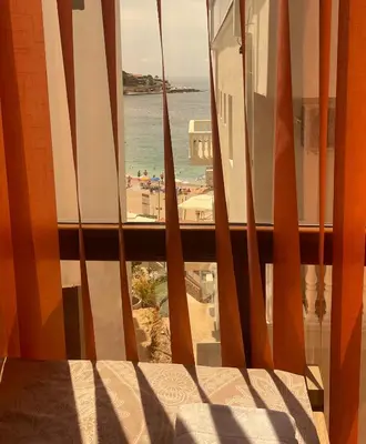a window with a view of a beach and the ocean at PETROVIĆ in Bar