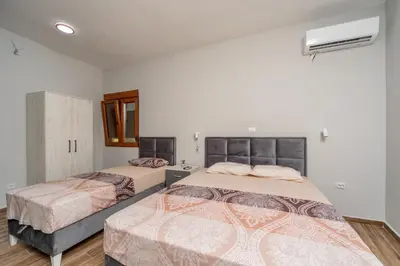 a bedroom with two beds in a room at PETROVIĆ in Bar