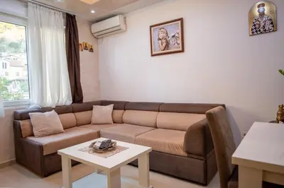a living room with a couch and a table at Apartman Milica-Mica in Kotor