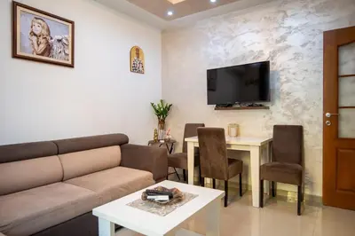 a living room with a couch and a table at Apartman Milica-Mica in Kotor
