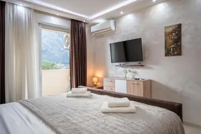 a bedroom with a bed with two towels on it at Apartman Milica-Mica in Kotor