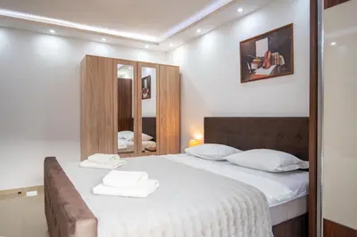 a bedroom with a bed with two towels on it at Apartman Milica-Mica in Kotor