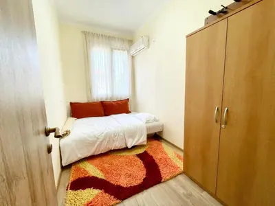 a small bedroom with a bed and a window at Plaza Centar Podgorica in Podgorica