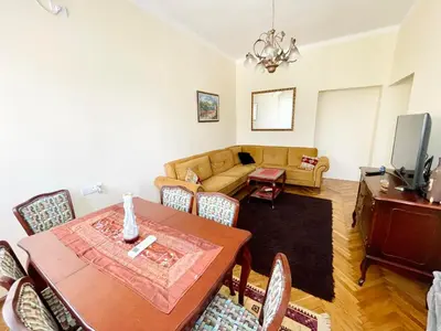 a living room with a table and a couch at Plaza Centar Podgorica in Podgorica