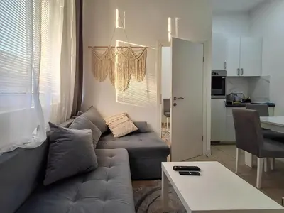 a living room with a couch and a table at One-Bedroom Apartment in the Center of Budva on a Quiet Street 5 Minutes to the Beach in Budva