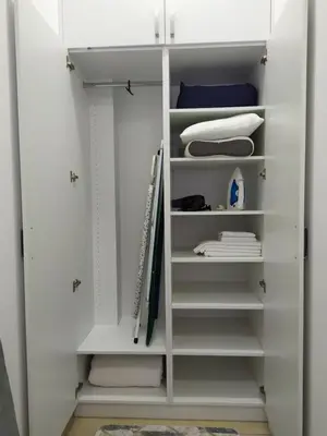 a white closet with white doors and shelves at One-Bedroom Apartment in the Center of Budva on a Quiet Street 5 Minutes to the Beach in Budva